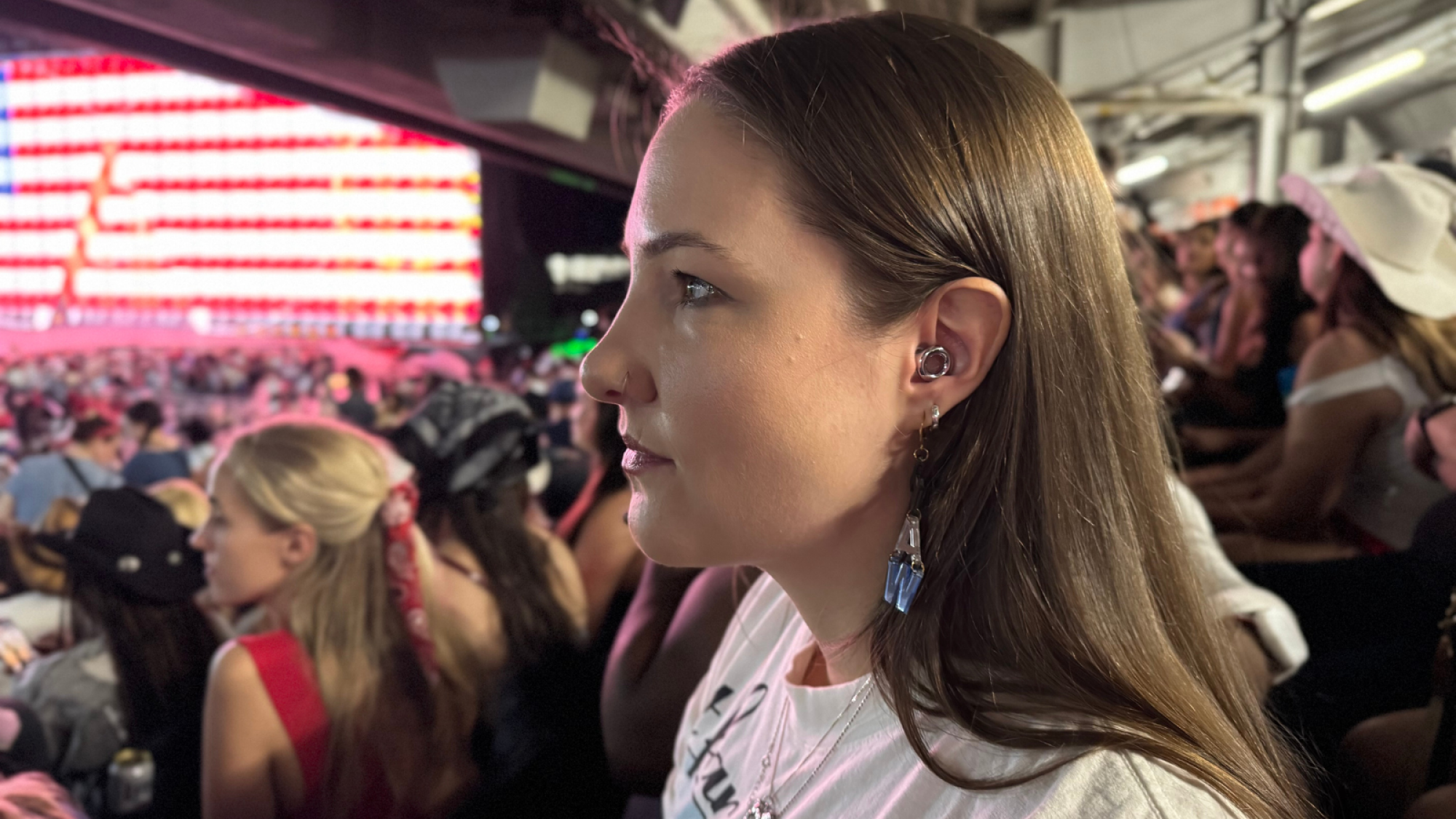 a side view of the author wearing loop experience 2 earplugs at the cowboy carter tour