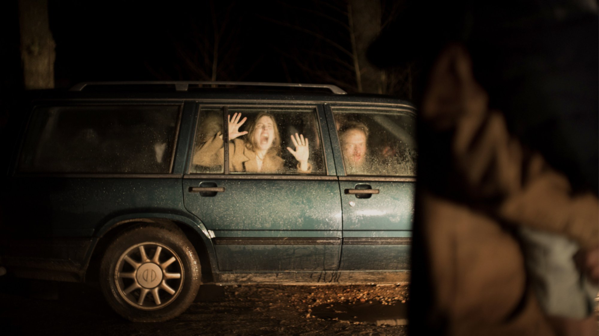 A woman trapped in car screams
